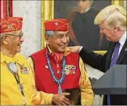  ?? OLIVER CONTRERAS / POOL / SIPA USA / ABACA PRESS / TNS ?? President Donald Trump greets Native American “code talkers” in a ceremony Monday in the Oval Office of the White House honoring their service during World War II.