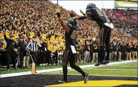  ?? CHARLIE NEIBERGALL / AP ?? Iowa tight end Noah Fant (left) celebrates with Ihmir Smith-Marsette after catching a 3-yard touchdown pass. Fant had two TD receptions.