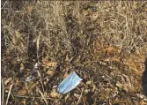  ?? WAYNE PARRY — THE ASSOCIATED PRESS ?? A discarded mask on a beach in Point Pleasant, N.J.