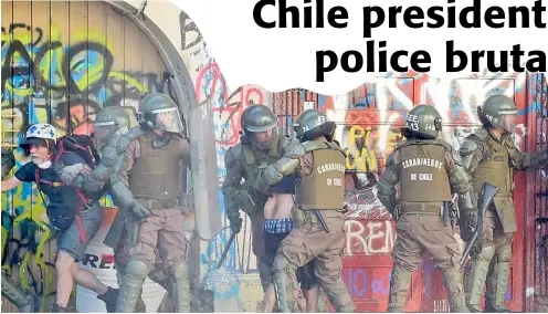  ??  ?? RIOT police arrest demonstrat­ors during a protest against the government in Santiago.