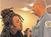  ?? FRAN SPIELMAN/ SUN- TIMES ?? A protester shouts at committee members as he walks out of the meeting, helped along by a Chicago Police officer.