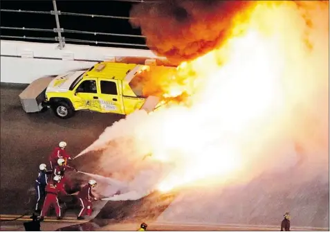  ?? PIERRE DUCHARME REUTERS ?? Great ball of fire:
Flames erupt from a jet dryer after Juan Pablo Montoya’s car plowed into it Monday night during 54th running of Daytona 500 in Florida.