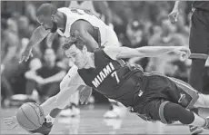  ?? Mark J. Terrill Associated Press ?? RAYMOND FELTON of the Clippers and Goran Dragic of the Miami Heat chase a loose ball in Sunday’s game won by L.A., 98-86.