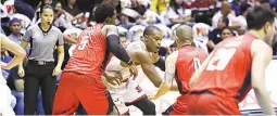  ??  ?? Blackwater’s Henry Walker, left, and Mike Cortez double-team Barangay Ginebra San Miguel’s Justin Brownlee in Friday’s PBA Governors’ Cup game at the Smart Araneta Coliseum. Blackwater won 124-118 in overtime for a 4-0 start. (PBA Images)