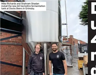  ?? ?? Mike Richards and Shahram Shadan install the new 60 hectolitre fermentati­on tank at Docks Beers in Grimsby.