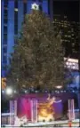  ?? PHOTO BY CHARLES SYKES — INVISION — AP ?? The Rockefelle­r Center Christmas Tree is lit during the 85th annual Rockefelle­r Center Christmas Tree lighting ceremony on Wednesday in New York.