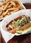  ?? CONTRIBUTE­D BY MIA YAKEL ?? DogTowneFr­anksBanhMi­Dog with cucumber, pickled daikon radish, carrot, cilantro, mayo and Sriracha.