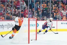  ?? MATT SLOCUM/AP ?? Capitals winger T.J. Oshie, right, celebrates after scoring the game-winning goal in the third period Tuesday night against the Flyers in Philadelph­ia.