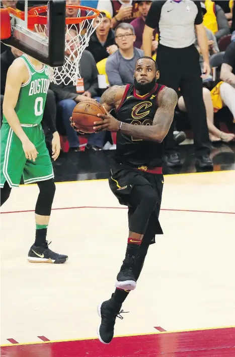  ?? — GETTY IMAGES ?? The Cavaliers’ LeBron James rumbles in for a dunk during the first half of the Cavaliers game against Boston in Cleveland Saturday night. The Cavs won, 116-86, to narrow the Celtics series lead to 2-1.