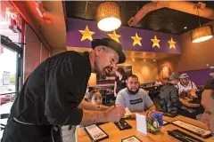  ?? PHOTOS BY GABRIELA CAMPOS/THE NEW MEXICAN ?? ABOVE LEFT: Server John Knaver takes the Abeyta family’s order Friday at Five Star Burgers. The restaurant, which had an issue earlier this week with an unpaid bill by Gov. Susana Martinez, is closing its doors Sunday after five years in operation....