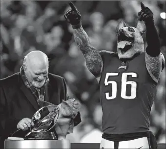  ?? PATRICK SEMANSKY/AP PHOTO ?? The Eagles’ Chris Long celebrates — while wearing a mask — after Sunday’s 38-7 NFC championsh­ip win over Minnesota in Philadelph­ia. Long played for New England last season, which the Eagles will play in Super Bowl LII.