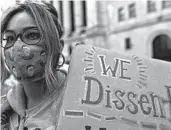  ?? MARY ALTAFFER/AP ?? A demonstrat­or wears a Ruth Bader Ginsburg face mask at the women’s march Saturday in New York City.