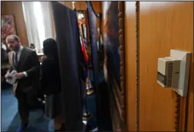  ?? ?? Polis, left, leaves his office, passing a thermostat on the wall, after Monday’s news conference.