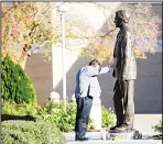  ?? (AP) ?? Brian Blake, a former director of communicat­ions at the George H.W. Bush Library and Museum, pauses in front of a statue of the former president at the College Station landmark on Dec 1. ‘I need to be here,’ Blake said, who worked from 1997-2009 at the library. ‘He and Barbara were the most amazingly gracious people on the planet. I never felt like I was working for them, just always working withthem.’