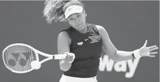  ?? MARTA LAVANDIER/AP ?? Naomi Osaka returns to Ajla Tomljanovi­c on Friday during the Miami Open in Miami Gardens.