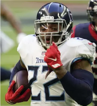  ?? AP PHoToS ?? OFF AND RUNNING: Titans running back Derrick Henry became the eighth running back to rush for 2,000 yards in a season. He scored two touchdowns to help Tennessee defeat Houston, 41-38. Below, Titans kicker Sam Sloman (2) watches his 37-yard game-winning field goal that banked off the upright.