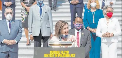  ?? Carolyn Kaster The Associated Press ?? House Speaker Nancy Pelosi of California, joined by House Democrats spaced for social distancing, speaks during a news conference Thursday on the House East Front Steps on Capitol Hill to talk about the George Floyd Justice in Policing Act.