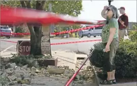  ?? Jessie Wardarski Tulsa World ?? JOYCE CHEATHAM surveys damage to her property in Pawnee, Okla. The record-tying magnitude 5.6 quake was felt across the Plains and as far as Iowa.