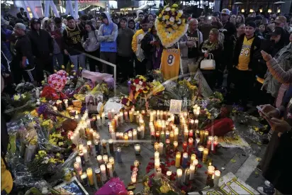  ?? MICHAEL OWEN BAKER — THE ASSOCIATED PRESS ?? People gather at a memorial near Staples Center after the death of Laker legend Kobe Bryant in Los Angeles.