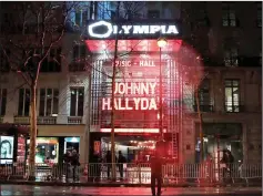  ??  ?? The Olympia Music theatre lights up with the name of Johnny Hallyday in Paris on Friday. France will hold a national funeral ceremony for beloved rock star Hallyday, who died this week at 74 after losing his battle with lung cancer. Hundreds of...