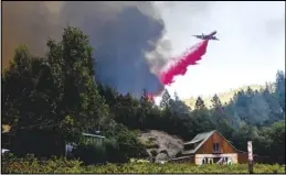  ?? AP PHOTO/NOAH BERGER ?? An air tanker drops retardant while battling the Glass Fire in St. Helena, Calif., on Sunday.