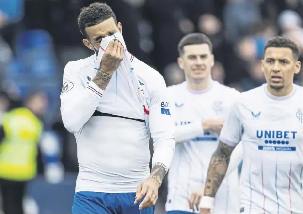  ?? ?? Connor Goldson, left, cuts a dejected figure after Rangers’ 3-2 defeat by Ross County