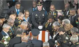  ?? AL DRAGO/GETTY ?? Members of the Congressio­nal Black Caucus pause Thursday at the casket of Rep. Elijah Cummings — the first African American lawmaker to lie in state in the U.S. Capitol.