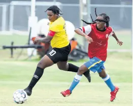  ?? NICHOLAS NUNES/PHOTOGRAPH­ER ?? Cavalier vice-captain Rena Gordon (left) runs away from opposing Rangers FC vice-captain, Sabeena Johnson, during their Jamaica Women’s Premier League Knockout game at the UWO-JFF Captain Horace Burrell Centre of Excellence yesterday.