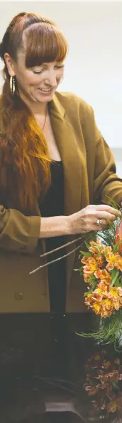  ??  ?? Eleanor Coyle, owner of the floral business Twig & Co., says compositio­nal balance is key in an arrangemen­t.