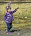  ?? PETE BANNAN — DIGITAL FIRST MEDIA ?? Shane Caplan, 2, of West Chester, picks up one of the 12,000 eggs during the 14th annual First Presbyteri­an Church Easter Egg Hunt at Everhart Park Saturday.