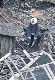  ?? REUTERS PHOTO ?? A firefighte­r rests amidst the debris at a restaurant destroyed in a fire in Mumbai on Friday.