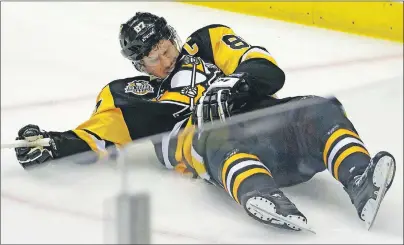  ?? AP PHOTO ?? Pittsburgh Penguins’ Sidney Crosby lies on the ice after taking a hit from Washington Capitals defenceman Matt Niskanen Monday.