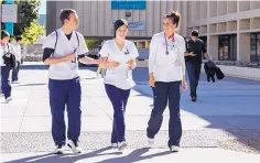  ?? COURTESY OF UNM ?? UNM College of Nursing students walk across campus. The nursing program has been ranked among the best in the country.