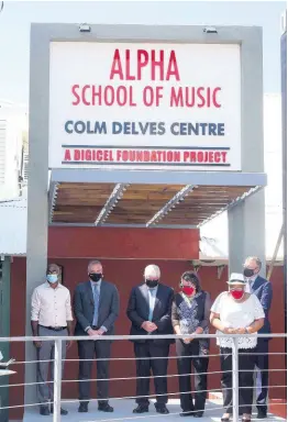  ??  ?? Digicel officials soak up the moment after the unveiling of the Alpha School of Music Colm Delves Centre on Tuesday.