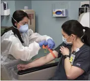  ?? PHOTO COURTESY OF BEAUMONT HEALTH ?? Rebecca Bacarella, from Beaumont Laboratory, was the first employee to register and have blood drawn for the test. Rita Hanna, phlebotomy, does the blood draw.