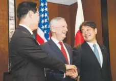 ?? Yong Teck Lim, The Associated Press ?? From left, South Korea's National Defense Minister Song Youngmoo, U.S. Defense Secretary Jim Mattis and Japan's Defense Minister Itsunori Onodera join hands before their trilateral meeting at the 17th Internatio­nal Institute for Strategic Studies...