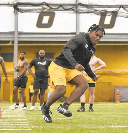  ?? MICHAEL THOMAS/AP ?? Ravens draft pick Tyler Badie runs a drill as he participat­es in Missouri’s Pro Day football workout for NFL scouts on March 25 in Columbia, Missouri.
