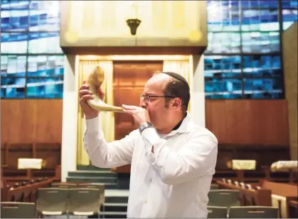  ?? Tyler Sizemore / Hearst Connecticu­t Media ?? Rabbi Daniel Cohen blows the shofar at Temple Agudath Sholom in Stamford on Sunday. Rosh Hashana, the Jewish new year, begins at sundown on Monday, marking the start of the High Holy Days.