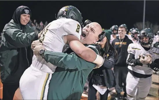  ?? Photograph­s by Wally Skalij Los Angeles Times ?? BRENDEN MOON gets a bear hug from Paradise assistant Nino Pinocchio after Moon returned an intercepti­on for a score against West Valley in a playoff game.