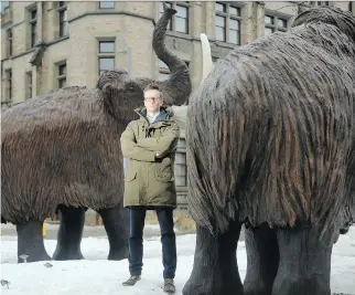  ?? JULIE OLIVER ?? Joe Bennett, a biology professor at Carleton University who specialize­s in conservati­on priorities, has just written a paper that does a cost-benefit analysis of resurrecti­ng extinct species — like the woolly mammoth here outside the Museum of Nature.