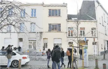  ??  ?? Reporters stand in front of an apartment (centre) in the Brussels district of Forest where a gunman was shot dead by Belgian police after a raid on the apartment linked to investigat­ions into November’s Islamist attacks in Paris. —Reuters photo