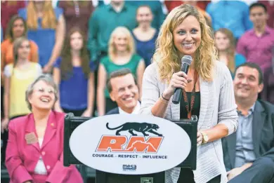  ?? MICHAEL SCHENNUM/THE REPUBLIC ?? Red Mountain High School teacher Nicki Derryberry accepts a $25,000 Milken Educator Award during a Monday assembly at the Mesa school.