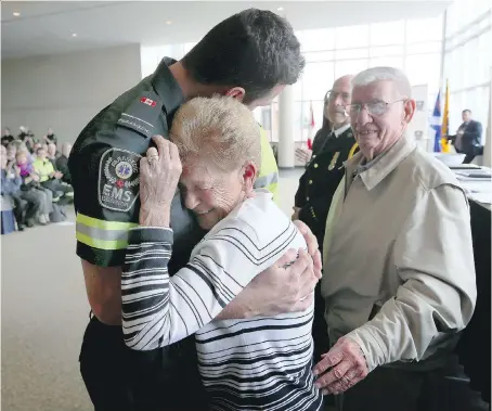  ?? NICK BRANCACCIO ?? Stroke survivor Joanne Lajeunesse hugs Essex-Windsor EMS paramedic Zach Livingston, left, on Friday during the Essex-Windsor EMS Survivor Day at St. Clair College Centre for the Arts. Joanne’s husband Clayton, right, called 911 when his wife collapsed...