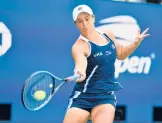  ?? ANGELA WEISS/GETTY-AFP ?? Top-ranked Ash Barty hits a return during a straight-set victory over Clara Tauson in Thursday’s second round of the U.S. Open in New York.