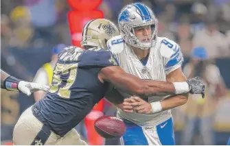  ?? | AP ?? Matthew Stafford coughs up the ball in the end zone as he is hit by Alex Okafor, resulting in a Saints TD.
