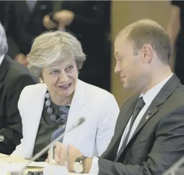  ??  ?? Theresa May speaks with Maltese PM Joseph Muscat during the EU summit in Brussels