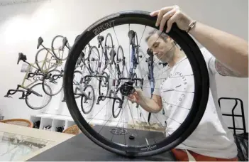  ?? — Reuters ?? A mechanic repairs bikes at the ‘Cafe du Cycliste’ shop in Nice, France, on Wednesday.