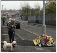  ?? AP/BRIAN LAWLESS ?? A woman in Londonderr­y, Northern Ireland, stops Saturday near the makeshift memorial for journalist Lyra McKee.