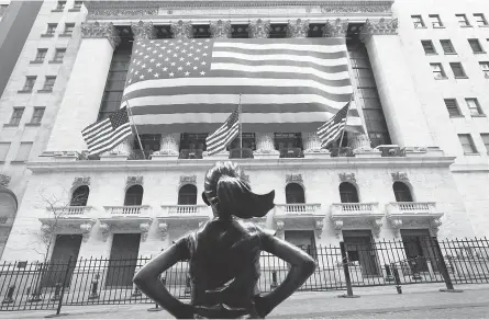  ??  ?? Stocks surged Tuesday as investors looked for more federal stimulus and progress on a virus vaccine. MARK LENNIHAN/ AP