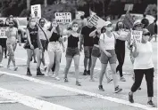  ?? MATIAS J. OCNER mocner@miamiheral­d.com ?? Protesters from a Black Lives Matter rally march toward Pines Trail Park in Parkland on July 11, 2020. A bill to stiffen penalties for crimes committed during a protest is expected to pass the Florida House along party lines on Friday.